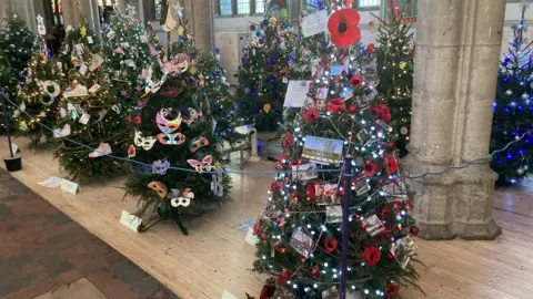 Luke Deal/BBC Christmas trees on display at Sudbury Arts Centre
