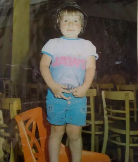 Christopher Higgins Christopher Higgins standing on a chair, wearing a Jaws T-shirt: caption: "We're going to need a bigger paddling pool"