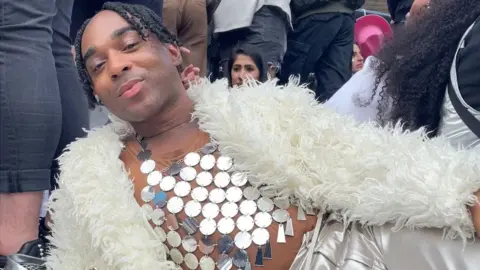 Samuel Quashie Man dressed in black-and-white natty cords