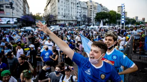 Getty Images Fans cheer for Diego Maradona after the news of his death