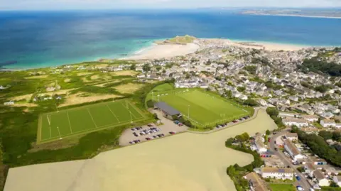 Stride Treglown An aerial view of the area created by the architects which shows where the new training ground, clubhouse and housing would be to the west of the town. St Ives Bay stretches into the distance.