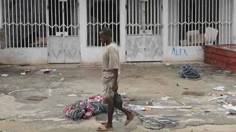 EPA Man walking past a shuttered shop