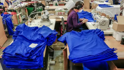 Getty Images Woman sews scrubs