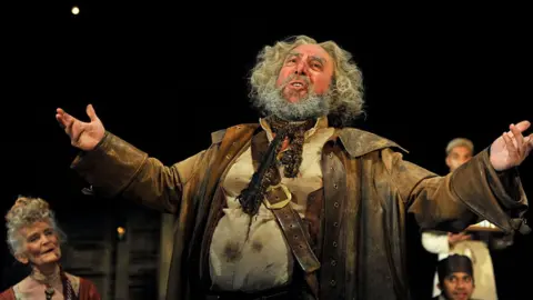 Getty Images Antony Sher as Sir John Falstaff with artists of the company in the Royal Shakespeare Company's production of William Shakespeare's Henry IV part I and II