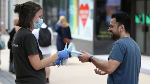 PA Media Bristol City Council staff hand out 80,000 face masks in Bristol city centre