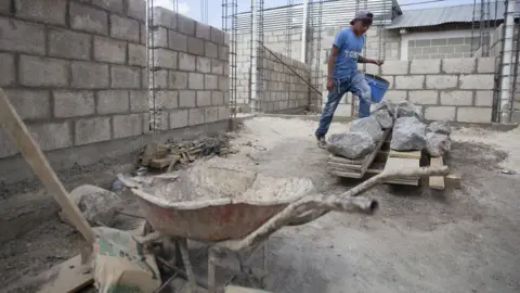 A man works on a construction site in Zunil