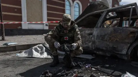 Getty Images Some volunteers look for traces to help identify the corpses at Kramatorsk railway station after the missile attack in Kramatorsk, Ukraine on April 09, 2022