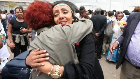 Reuters Relatives embrace after meeting at Asmara International Airport, after one arrived aboard the Ethiopian Airlines ET314 flight in Asmara, Eritrea July 18, 2018.
