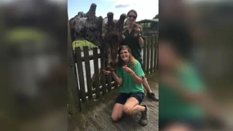 Folly Farm  Folly Farm staff with a giraffe