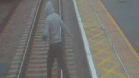 Greater Anglia Man on railway tracks at Broxbourne station