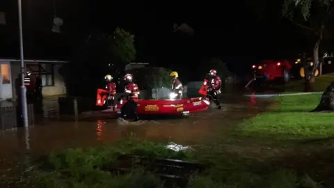 rescue boat at flooded derry house