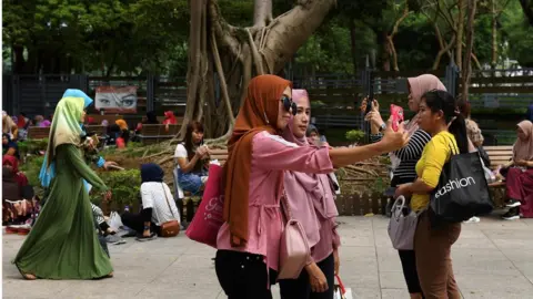 Getty Images Indonesian domestic workers in Hong Kong