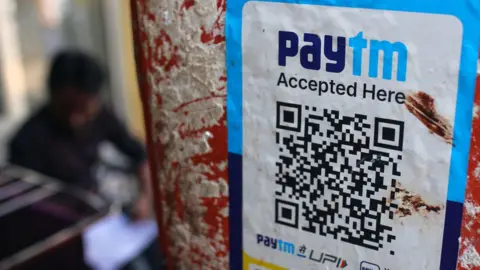 Getty Images A QR code for the Paytm digital payment system at a store in Mumbai, India, on Thursday, Feb. 1, 2024. Shares of digital-payments provider Paytm plunged 20% after Indian regulators ordered it to halt a bulk of its business, dealing a severe blow to a high-profile tech pioneer that grappled for years with authorities.