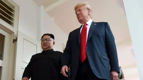 AFP North Korea"s leader Kim Jong Un (L) walks with US President Donald Trump (R) at the start of their historic US-North Korea summit