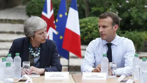EPA Macron and Theresa May