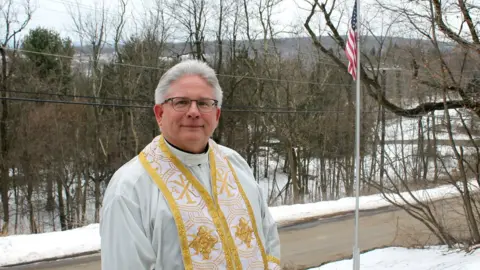 BBC Father Michael Hutsko outside the Assumption of the Blessed Virgin Mary Ukrainian Catholic Church in Centralia