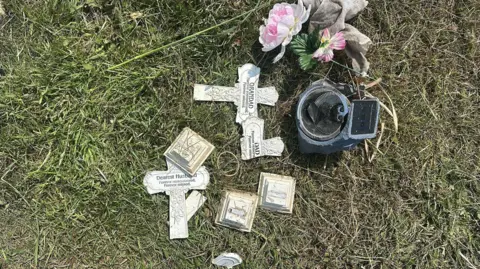 Supplied Broken ornamental crosses and an artificial flower holder