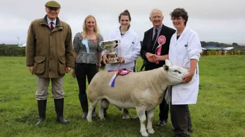 CALLUM STALEY/CSJ PHOTOGRAPHY The Creer family with their Texel ram