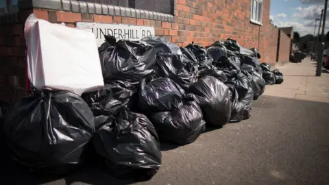 Getty Images Bin bags piled up in Alum Rock