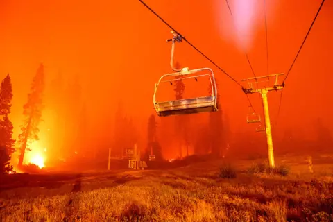 Josh Edelson / AFP Flames surround a chair lift at Sierra-at-Tahoe resort, a skiing area, during the Caldor fire in Twin Bridges, California, US on 29 August 2021
