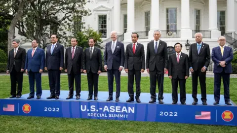 Getty Images U.S. President Joe Biden (C) with (L-R)Dato Lim Jock Hoi, Prime Minister of Vietnam Pham Minh Chinh, Prime Minister of Thailand Prayut Chan-o-cha, Prime Minister of Cambodia Hun Sen, Sultan of Brunei Haji Hassan, President of Indonesia Joko Widodo, Prime Minister of Singapore Lee Hsien Long, Prime Minister of the Lao Peoples Democratic Republic Phankham Viphavan, Prime Minister of Malaysia Dato Sri Ismail Sabri bin Yaakob and Secretary of Foreign Affairs of the Philippines Teodoro Locsin.