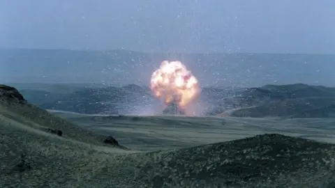 Getty Images / TASS An explosion in a huge open plain of rolling green fields