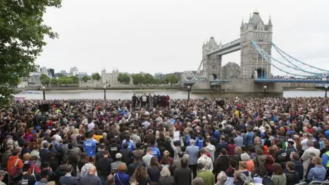 PA Mayor of London Sadiq Khan, Home Secretary Amber Rudd and Shadow Home Secretary Diane Abbott with members of the public at a vigil in Potters Fields Park, central London