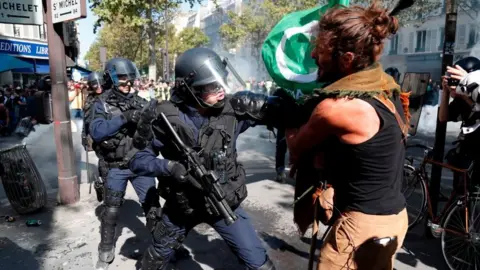 Getty Images A police officer in a stand-off with a protester