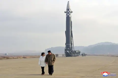 KCNA via Reuters North Korea's leader Kim Jong-un is seen standing hand-in-hand with his daughter in this photo released by KCNA news agency