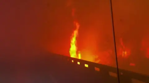 Flames raging along road in Texas wildfire