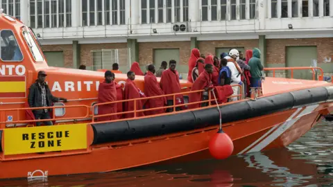 Getty Images Migrants brought ashore in Spain