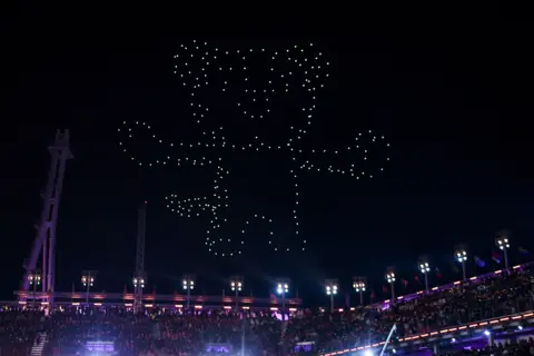 Getty Images Drones light up the sky above the Olympic stadium