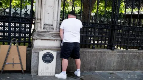 Alamy Live News A man appearing to urinate on PC Keith Palmer's memorial