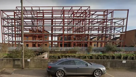 Google Maps The metal skeleton of Amleen House during its construction in November 2020