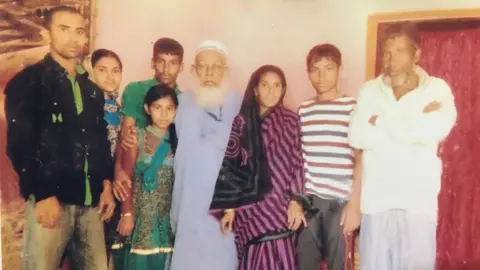 BBC Kamru (centre) with family in Bangladesh