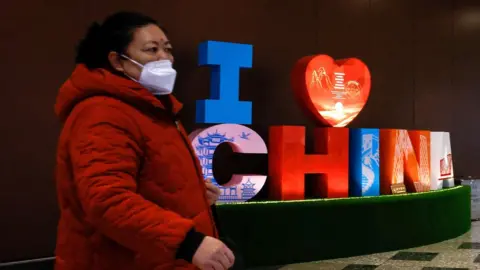 EPA Woman walks through Beijing Daxing International Airport in Beijing