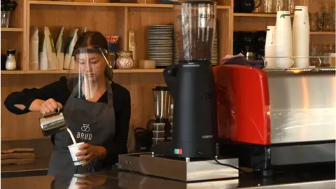 Getty Images A woman working in a cafe