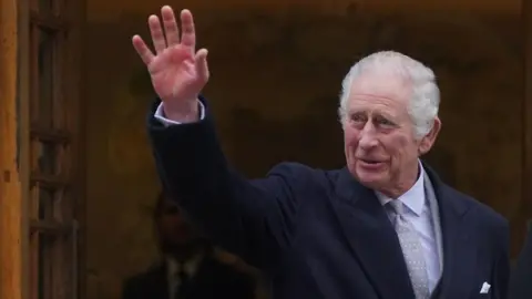 PA Media Prince Charles waves to wellwishers outside the London Clinic