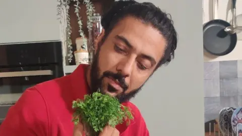 Chef Ranveer Brar with a bunch of coriander