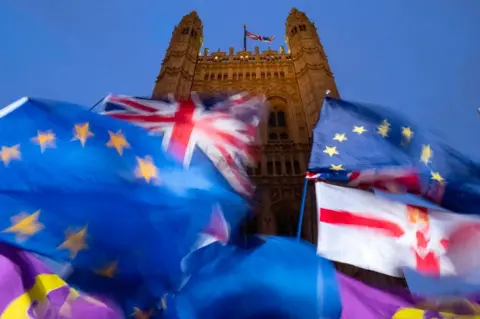 Getty Images EU and union flags flying outside the Palace of Westminster