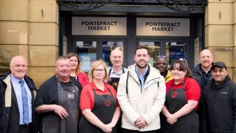 Wakefield Council Councillor Michael Graham (centre) with market traders and other representatives