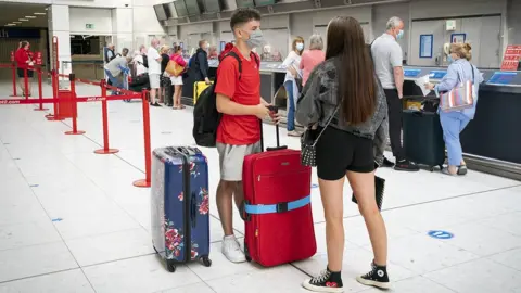 PA Media boy and girl at airport
