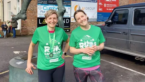 Nichola Rutherford Nichola and sister outside Brunton Park in Carlisle, after completing 10K race

