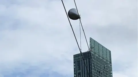 Network Rail Helium balloon caught on overhead electric cables in Manchester