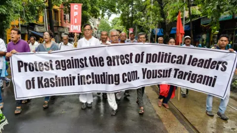 Getty Images Members of the Left Front parties march with a banner during a protest rally against scrapping of Article 370 in Kolkata