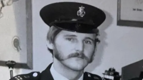 Handout A black and white image of Eric Noble in his police uniform and hat from 1980