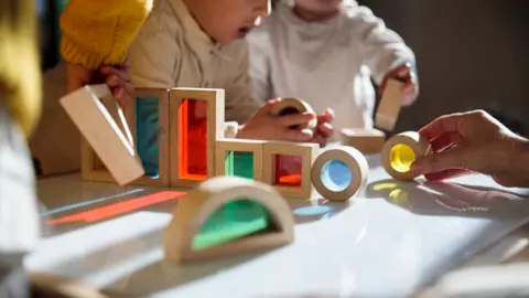 Getty Images Children playing at table