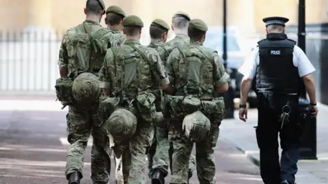 Getty Images Soldiers arriving near Buckingham Palace in London in May 2017 as 984 military personnel are deployed around the country following the Manchester Arena Terror Attack