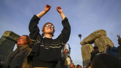 AFP Woman celebrating at Stonehenge