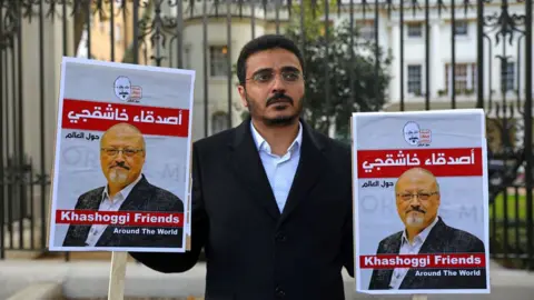 Reuters A man protests outside the Saudi embassy in London against the killing of Saudi journalist Jamal Khashoggi (26 October 2018)